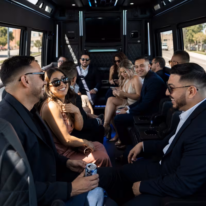 Wedding guests seated inside a San Jose party bus