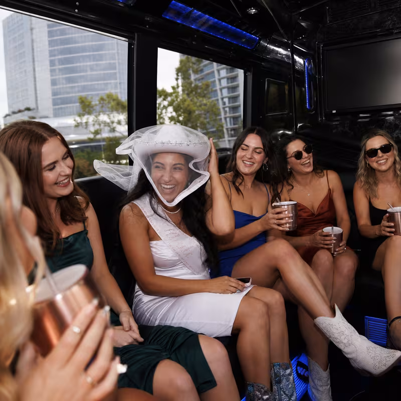 Party bus interior with wraparound leather seating and LED lighting in San Jose