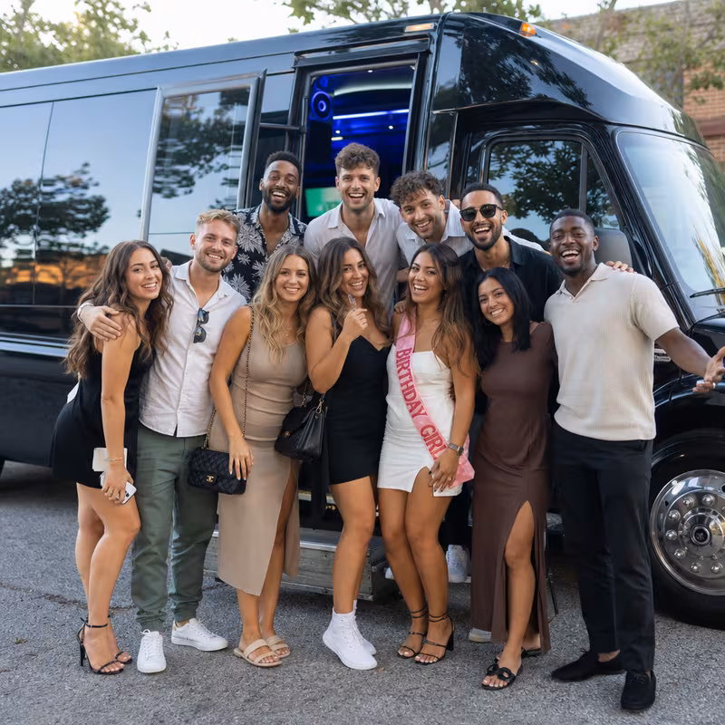 Group boarding a white charter bus for Birthday Transportation transportation in San Jose