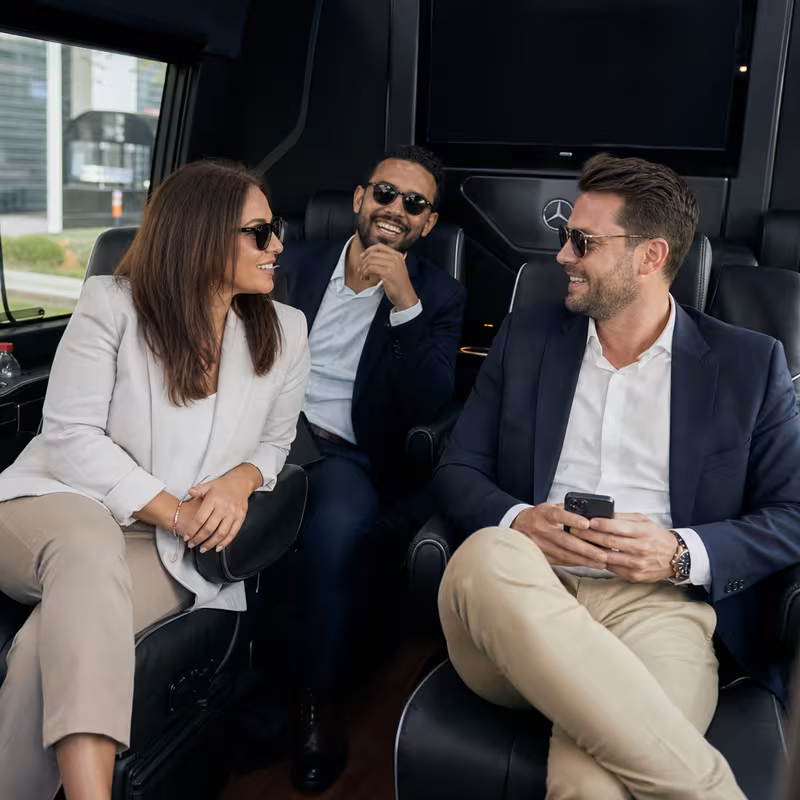 Group boarding a white charter bus for Corporate Transportation transportation in San Jose