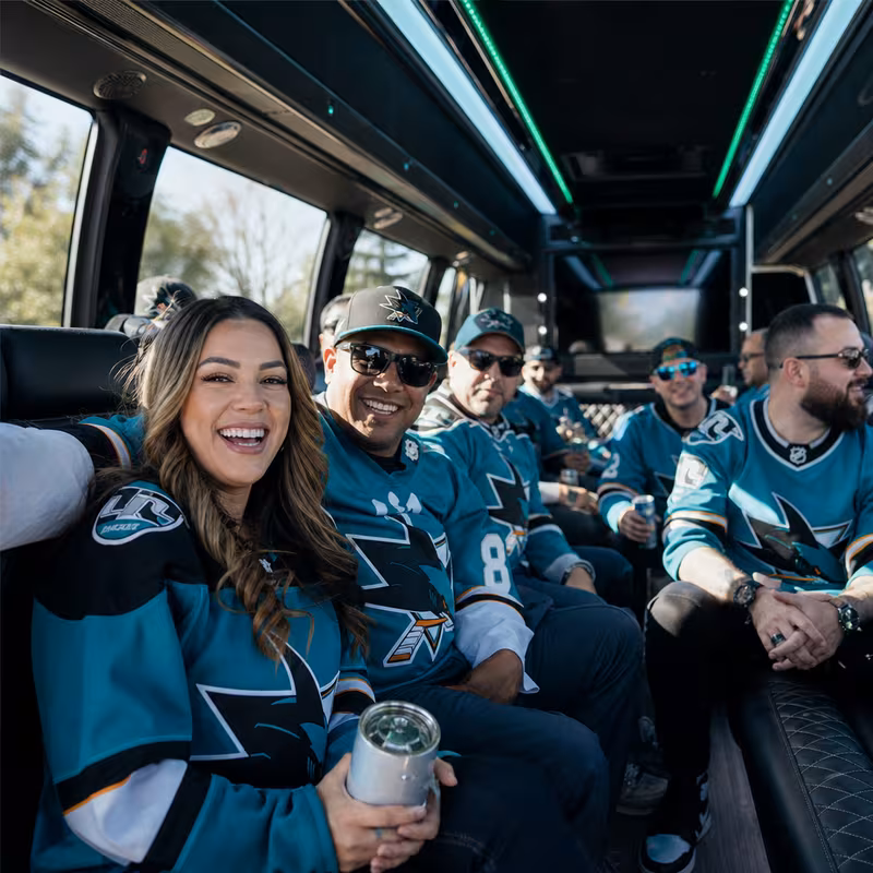 Group boarding a white charter bus for Sporting Event Transportation transportation in San Jose