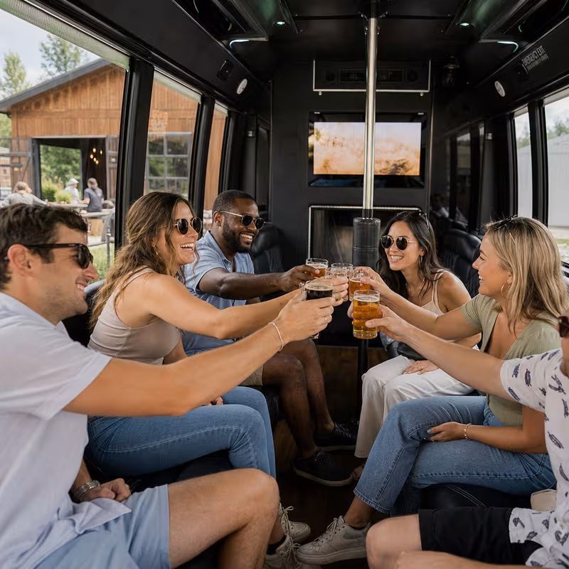Group boarding a white charter bus for Winery & Brewery Tour Transportation transportation in San Jose