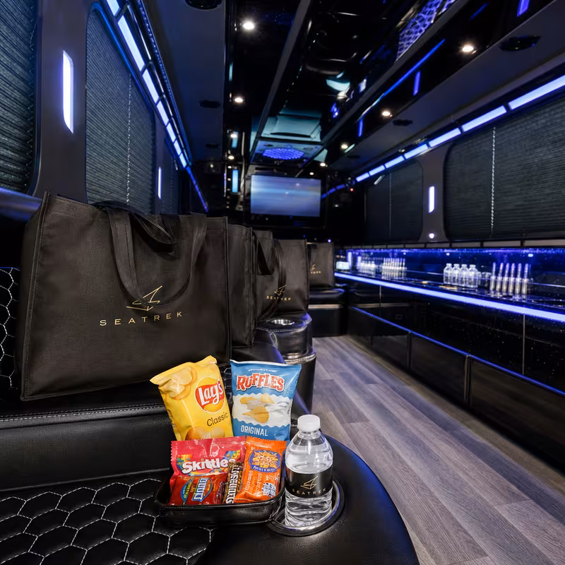 Party bus interior with wraparound leather seating and LED lighting in San Jose